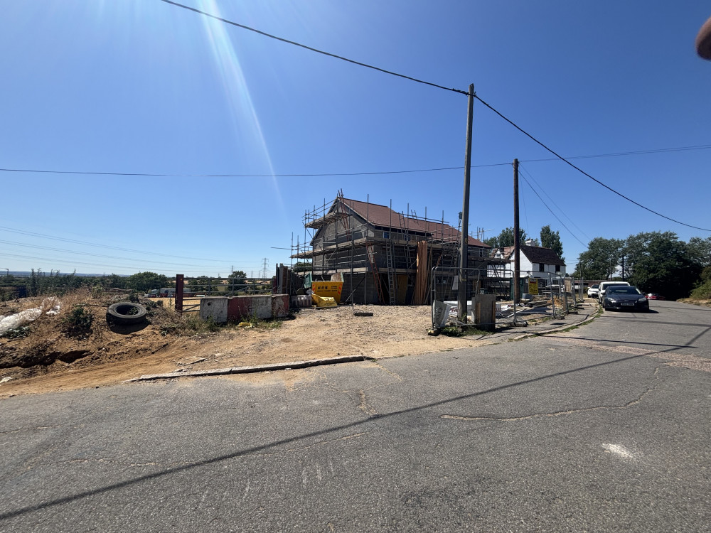 Entrance to the site and adjacent homes under construction. Entrance to the site and adjacent homes under construction.