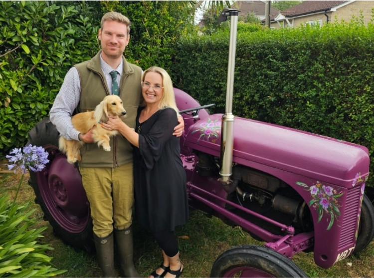 Tobias, Heather, dog Teddy and their vintage tractor.
