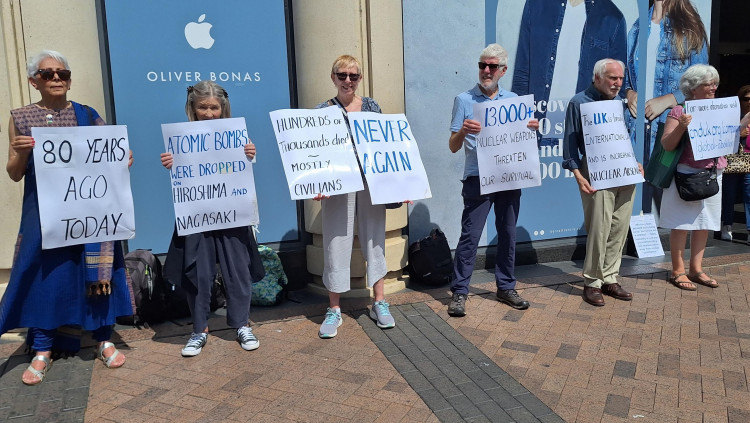 Peace campaigners mounted a silent vigil in Kingston Town Centre holding placards to explain the significance of the day in history (Credit: Kingston Peace Council)