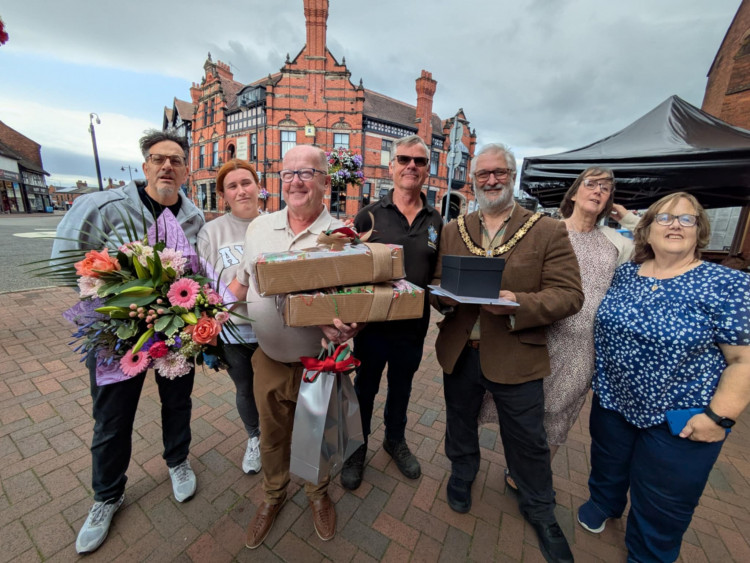 Floristry business owner holds his hampers at the presentation. (Photo: Nub News) 