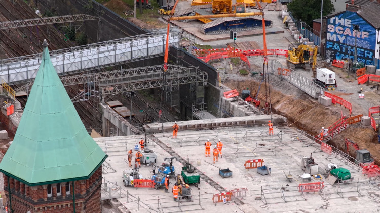 A drone image showing a concrete beam being lifted out of the old Greek Street bridge (Image - Network Rail)