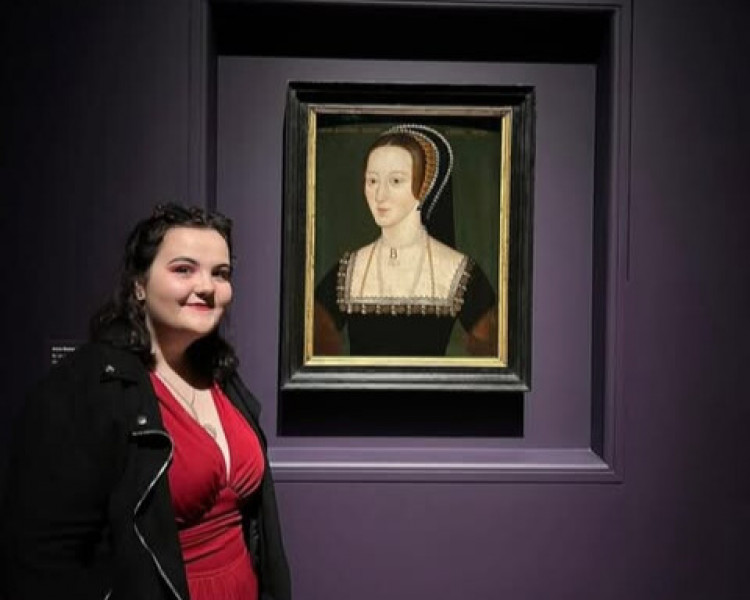 Local academic, Jessica Faulkner, next to a portrait of Anne Boleyn (Image supplied)
