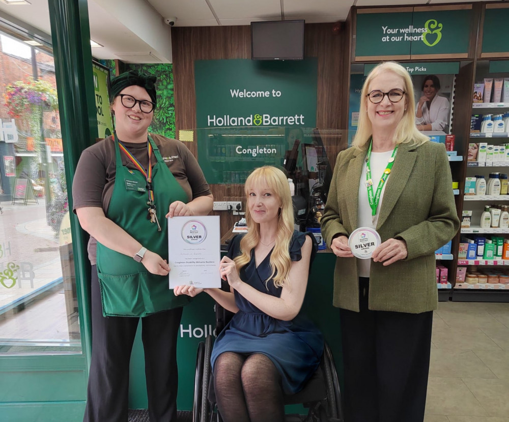 Holland & Barrett manager Robin Hughes accepts the Disability Welcome Silver Award from Dr Lawson and councillor Wesley (Credit: CTC)