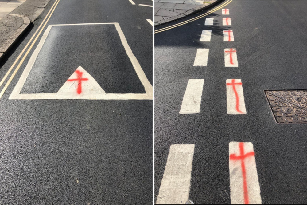 Red cross graffiti painted over white road markings in Twickenham has been condemned by councillors as vandalism and a hazard for drivers (credit: AlexanderEhmann/X). Red cross graffiti painted over white road markings in Twickenham has been condemned by councillors as vandalism and a hazard for drivers (credit: AlexanderEhmann/X).