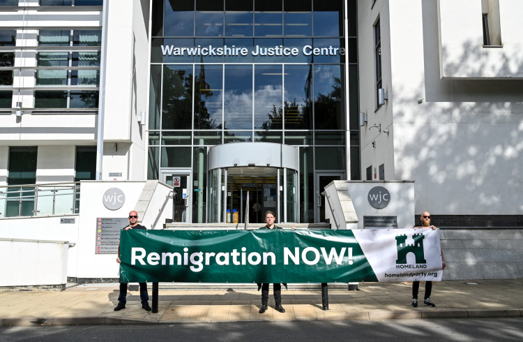 The banner read 'Remigration NOW!' (image via SWNS)