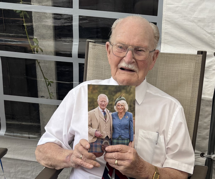 Jim with his card from King Charles and Queen Camilla.
