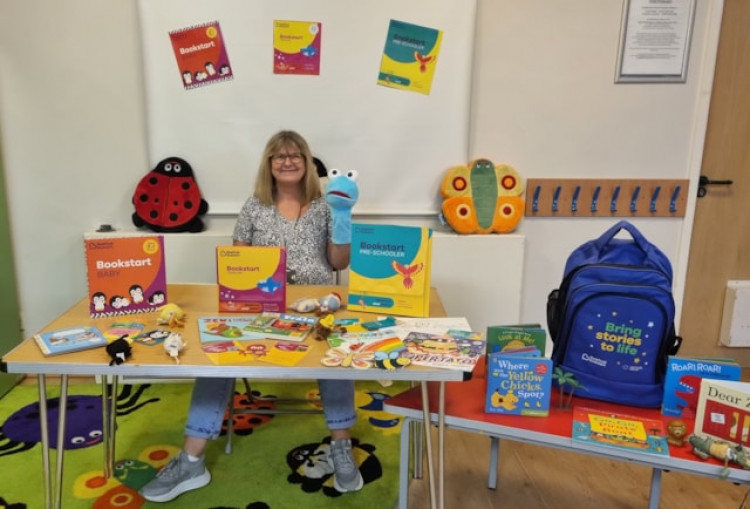 One of the Family Hub facilitators, with some of the Bookstart activities families can expect to enjoy at East Tilbury Library