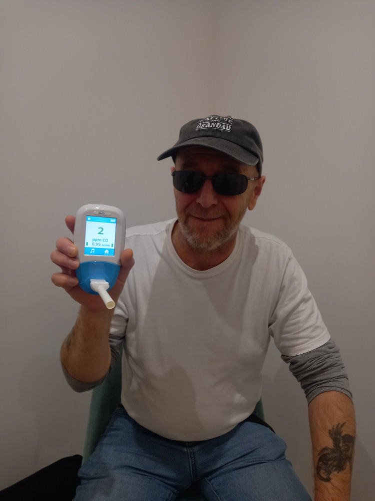 Be Smoke Free member David, blowing 2ppm on the carbon monoxide monitor (level of CO which anyone can have due to pollution.) Davids levels gone down from moderate smoker to non-smoker.