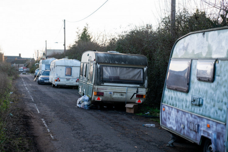 Glastonbury faces a van-living crisis, prompting MP Sarah Dyke to seek a national caravan licensing system amid unsafe conditions and a lack of infrastructure.