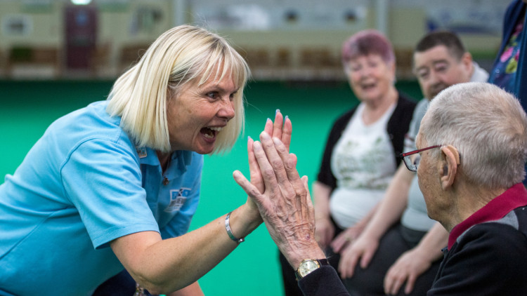 Sporting Memories Volunteer high fives Club member (credit: Image supplied).