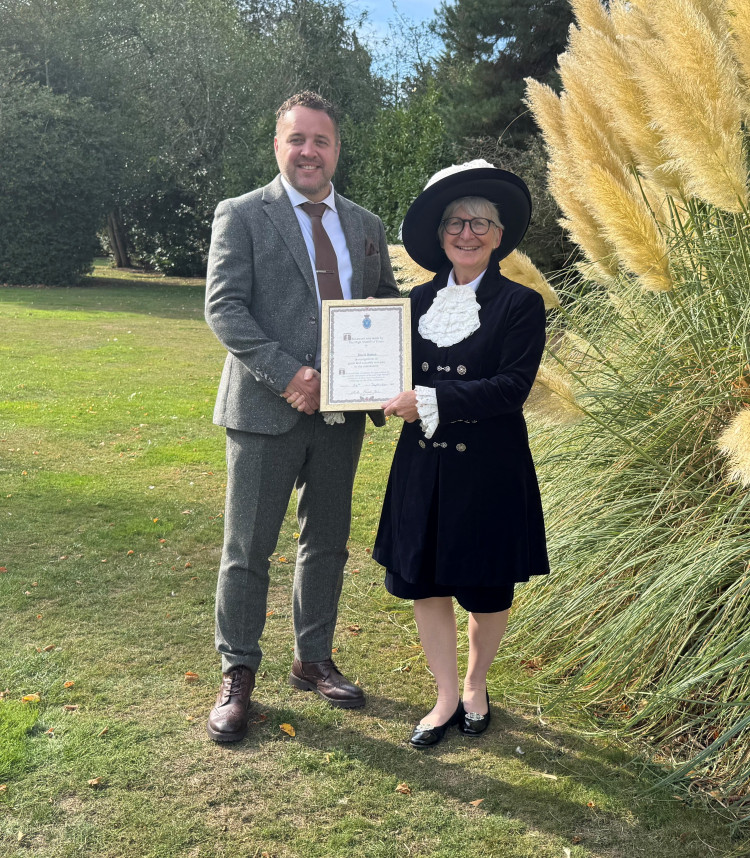 David Barton receives his certificate of recognition
