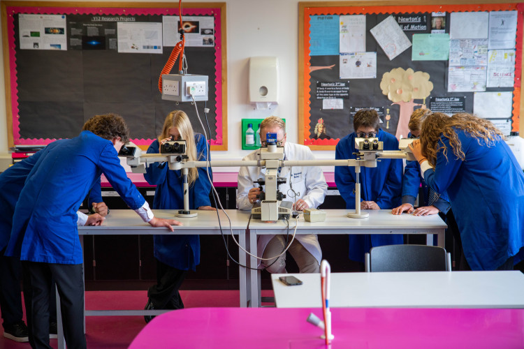 Kew House A-Level biology pupils using the advanced teaching microscope donated by Great Ormond Street Hospital, which once played a key role in treating childhood leukaemia (credit: Kew House School).