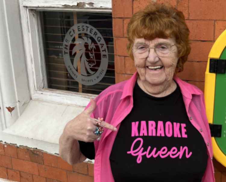 Molly pictured in 2023, unveiling the new defibrillator outside The Chestergate pub (Image - Blind Tiger Inns)