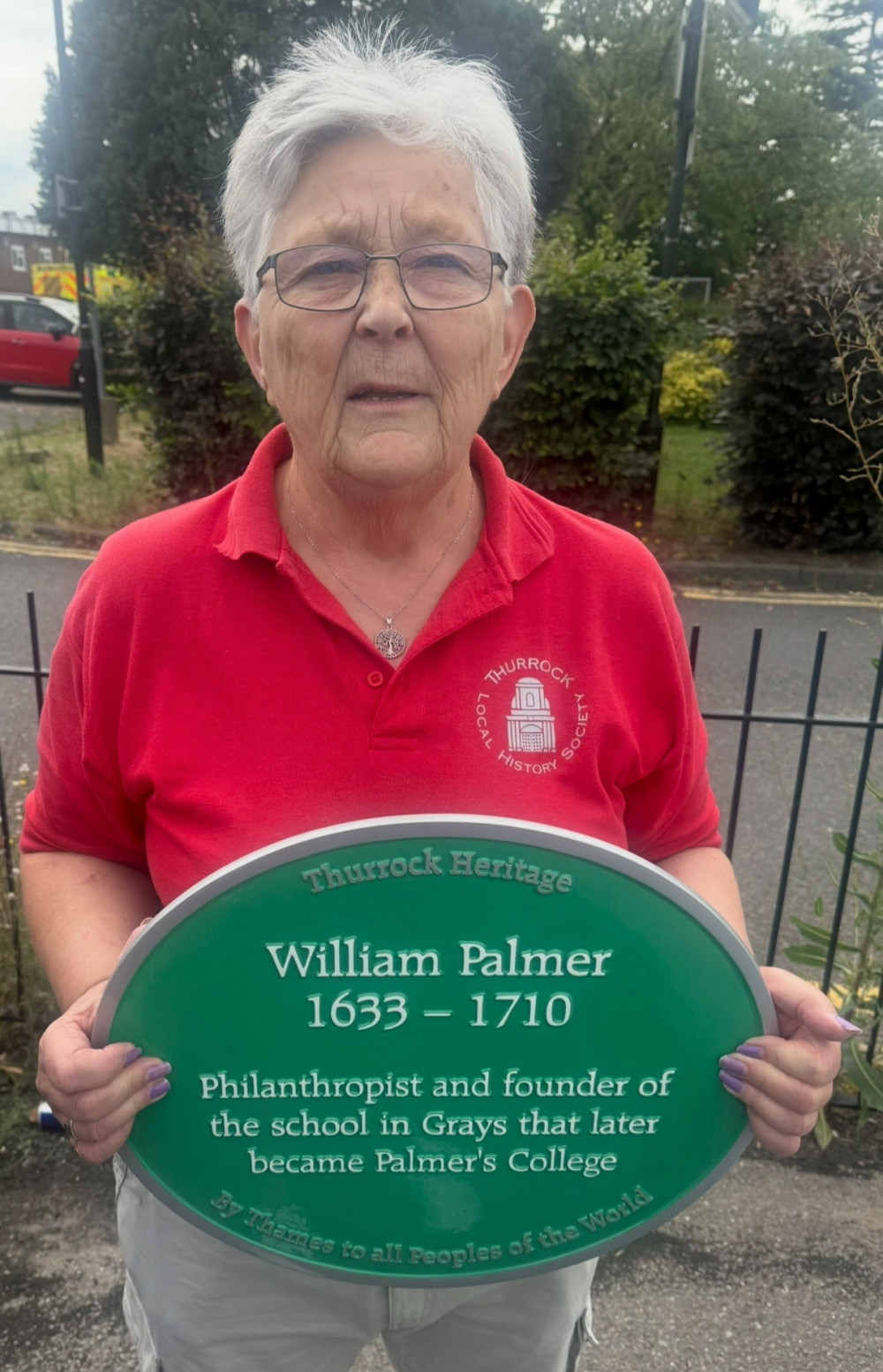 Susan Yates with the plaque to be mounted today. 