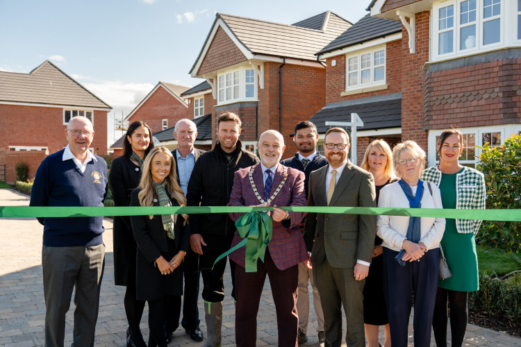 Congleton Town Mayor Robert Brittain cuts the ribbon to open the new show homes at Woodland Manor (Credit: Castle Green Homes)