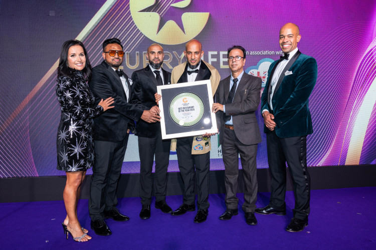 The East 360 team receiving the award from Ben Obese-Jecty MP and the celebrity host Nina Hossain (Credit: Curry Life Awards)