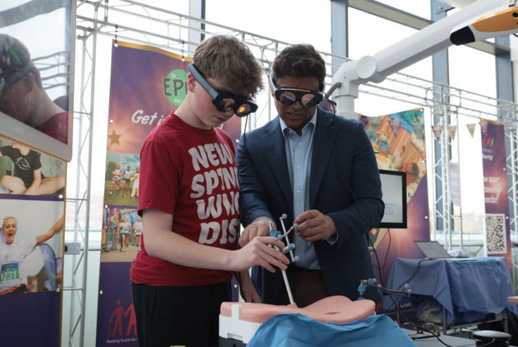 Mr Vinay Jasani, consultant spinal surgeon and Dylan Jaxon (image via uhnm.nhs.uk)