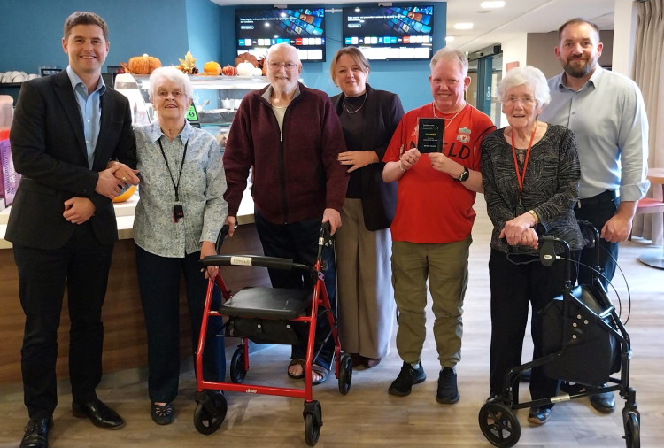 Belong customers celebrate the HealthInvestor Seniors Housing Award win with representatives from Belong's management (image via Belong)