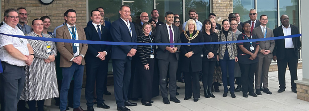 Minister of State for Health, Dr Zubir Ahmed about to cut the ribbon in front of guests and staff. Minister of State for Health, Dr Zubir Ahmed about to cut the ribbon in front of guests and staff.