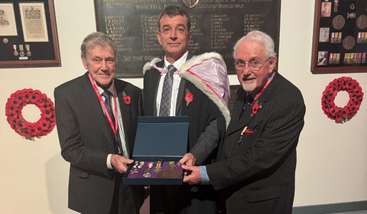Alan Batchelor and David Hill present the medals to head of foundation, Jason Slack (Credit: King's School)