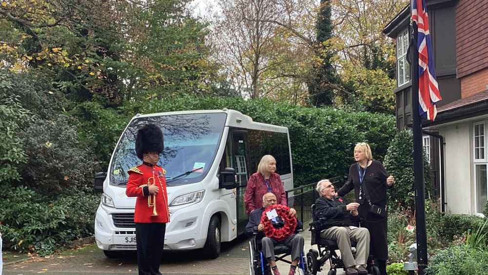 : Army veteran Michael raises the Union Flag outside the Surbiton Home  (Credit: Royal Star & Garter)