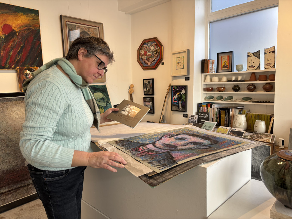 Barewall Art Gallery Director, Amanda Bromley, with some of the found artworks (image via Nub News)