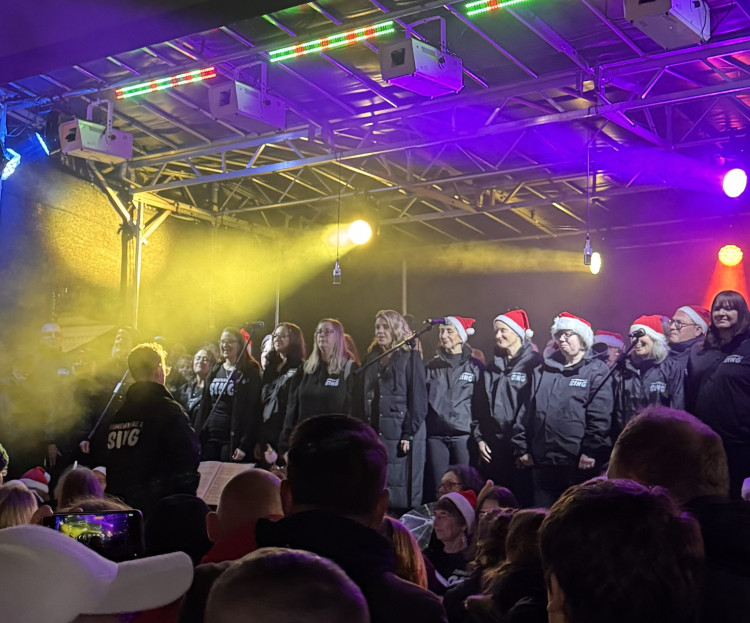 Singers at the Christmas lights turn on 