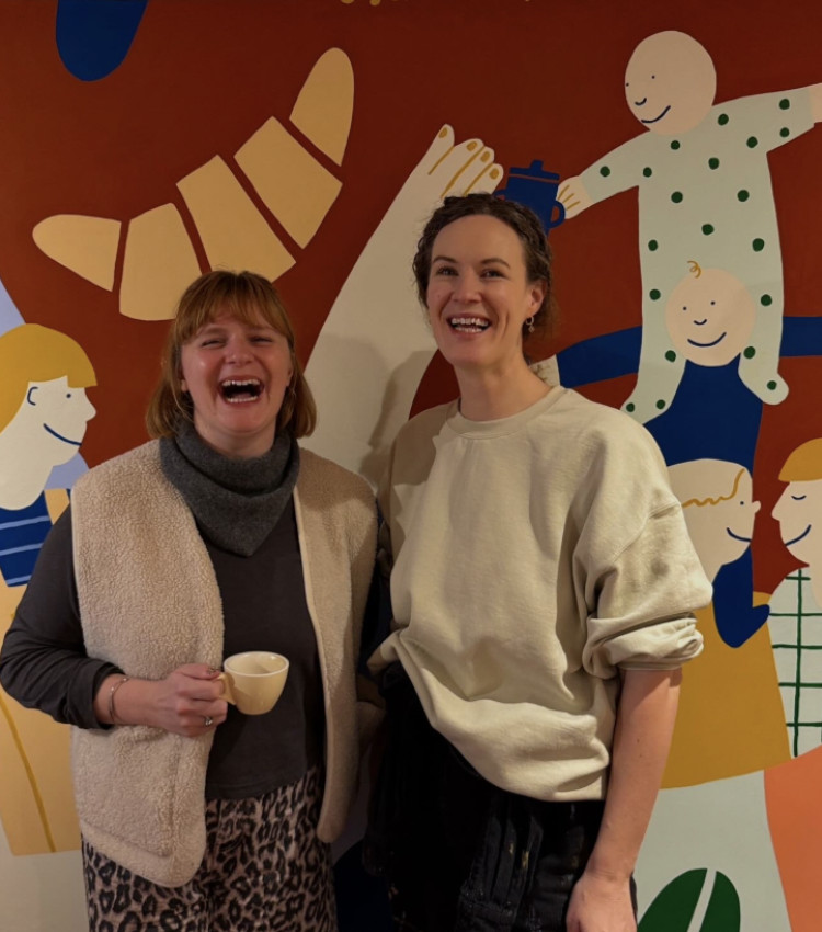 Katie Jensen (left) with Emily Marlowe (right) in front of the new mural at Lola café in Leamington (image via Emily) 