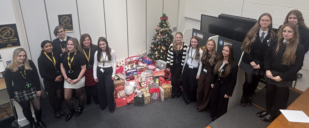 Mrs Julie Willett with students from St Clere's School and Sixth Form and some of the collected gifts. 