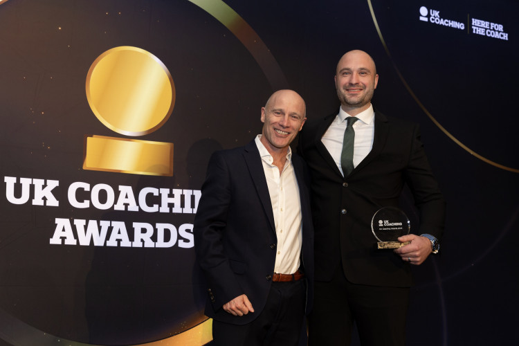 John Hewitt (right) collects his award at the UK Coaching Awards ceremony (Image supplied)
