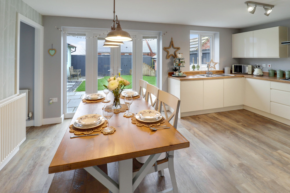 Spacious, modern kitchen diner with integrated appliances and French doors opening onto the private rear garden
