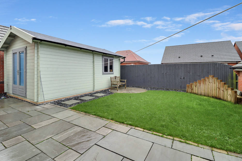 Private, low-maintenance rear garden featuring a versatile summerhouse—ideal as an office, gym or relaxation space