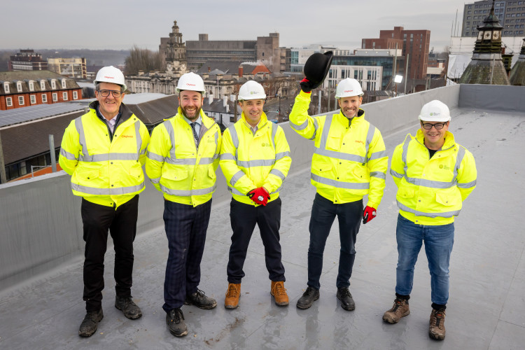 The project team at Stopford Park celebrated the topping out of Bosden by raising a hat in a nod to Stockport's hatting heritage (Image - CityHeart)