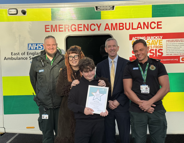 Ryan Reader (centre) proudly holds his bravery award. Also pictured, from left to right: Paramedic Stuart Wilkinson, Ryan’s mum Kat, EEAST CEO Neill Moloney, and call handler Sean Austin.