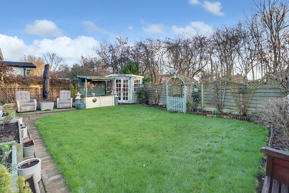 Private, well-maintained garden with lawn, flower beds and seating areas