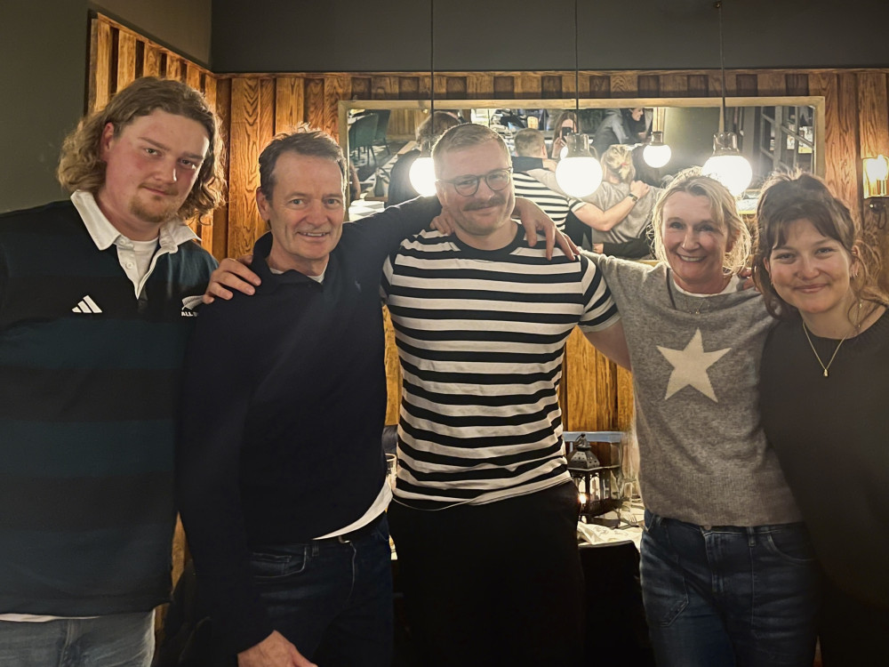 Former Richmond resident Max (centre) was flown home from Australia to reunite with his family for the first time in five years (credit: PizzaExpress).