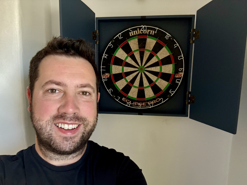 Rob Jeffries in front of his home dartboard where he’s been practicing (Image via: Rob Jeffries) 