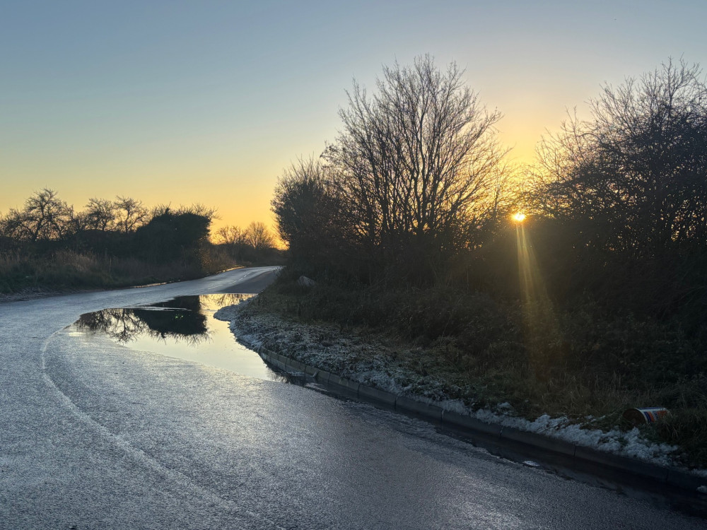 A scenic sunset but danger lurks with deep standing water on Butts Lane.