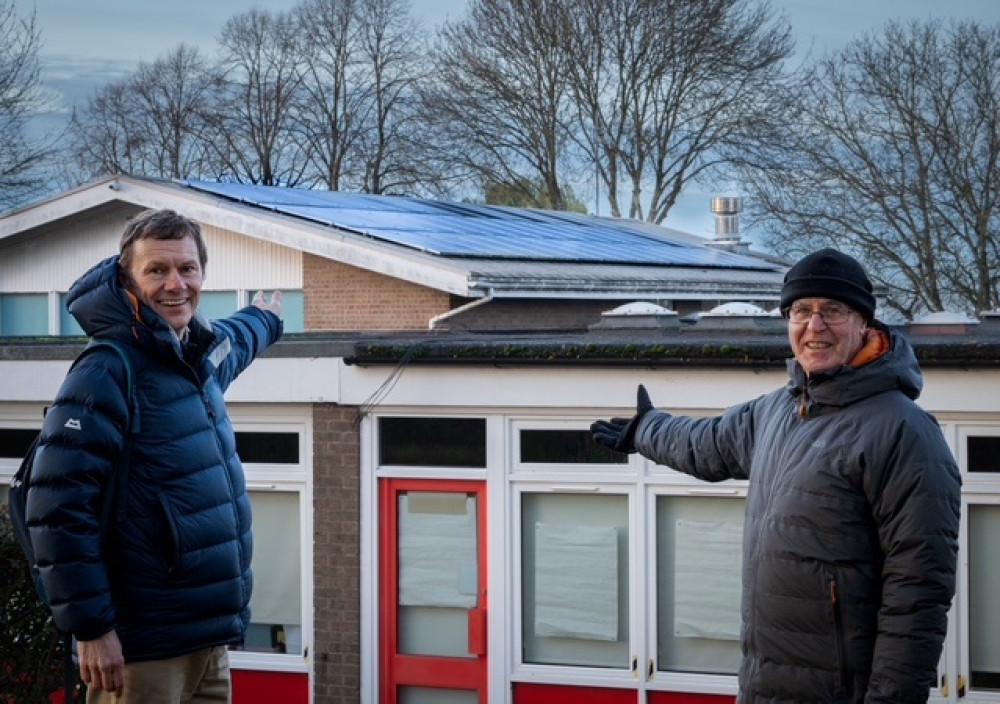Paul Quinney (left) and Bob Sherman (right) of Harbury Future Energy stand outside Harbury C of E Primary School with its rooftop solar panels