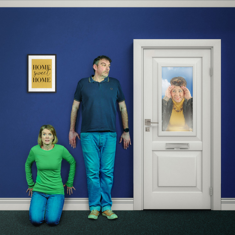 Peter (Mark Plastow - L) and Debbie (Esther Riggs - FL) hide from Elsa (Julie-Ann Randell - R) peering through the window after inviting herself to stay (image by Robert Warner)