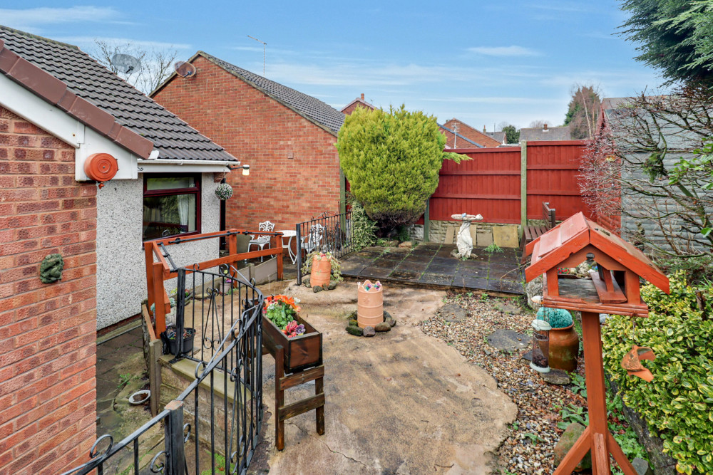 Private south-facing landscaped garden with paved patio, perfect for relaxing and summer seating