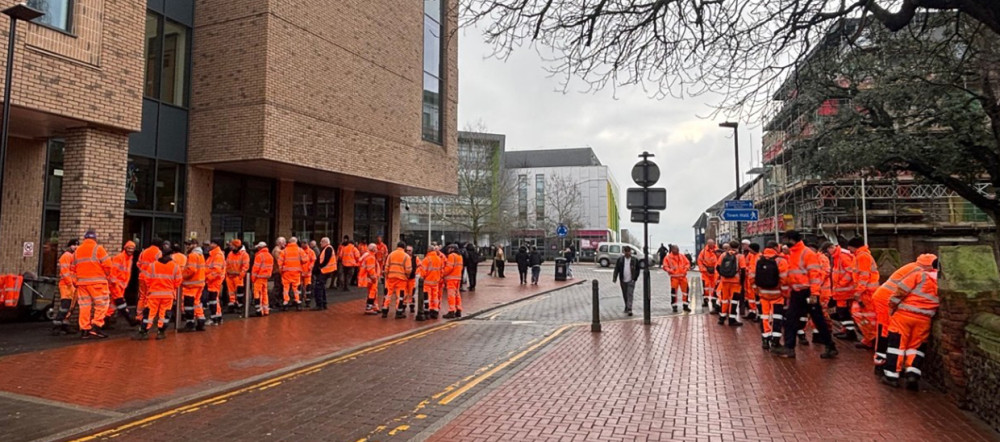 Hi profile - Orange-clad workers gathered at the town hall.