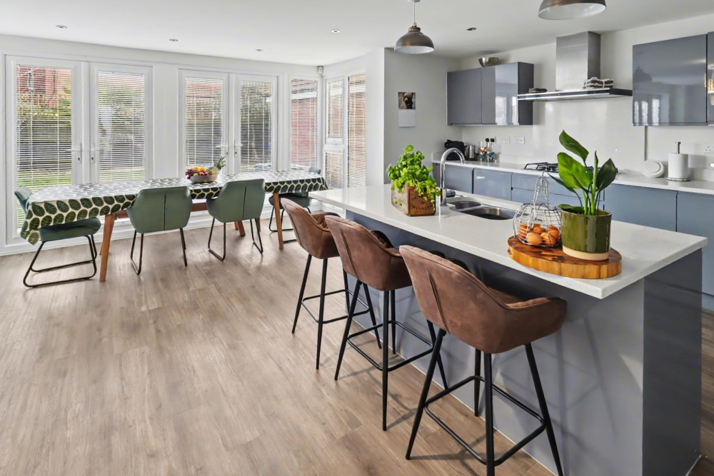 Bright open-plan kitchen, breakfast and family area with premium appliances, central island and French doors to the garden
