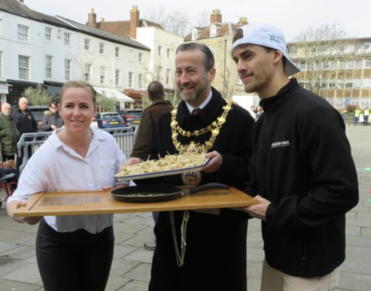 Staff from The Globe Hotel circulated with trays of small pancakes as local business signed in at last year's Pancake races(image via Warwick Rotary Club)