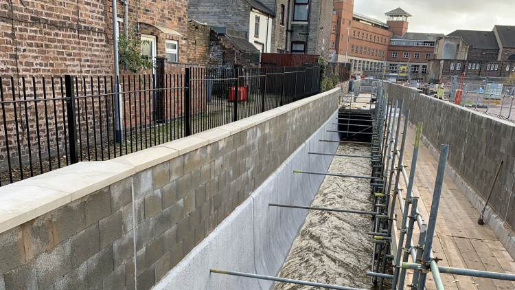 The flood wall during construction (image via the Environment Agency)