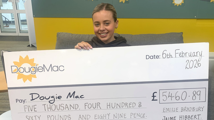 Emilie Bradbury with the cheque (image via Dougie Mac)