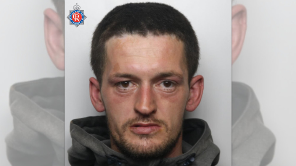 34-year-old Calum Brennan is wanted in connection with a burglary in Denton (Image - GMP)