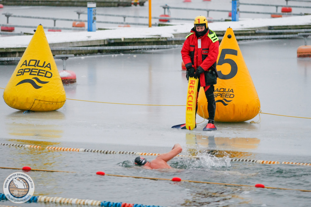 Safety first: a rescue diver stands ready on the ice while Neil tackles the 1km