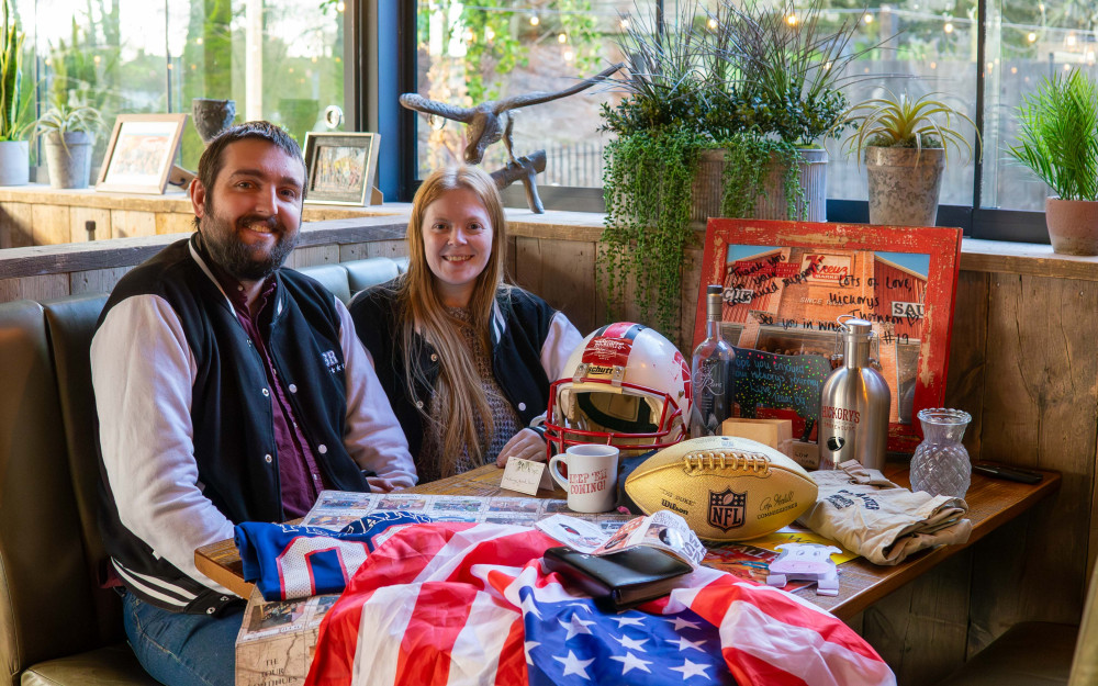 Simon and Amanda Richards with their memorabilia from 13 years of building memories through BBQ (Image supplied)