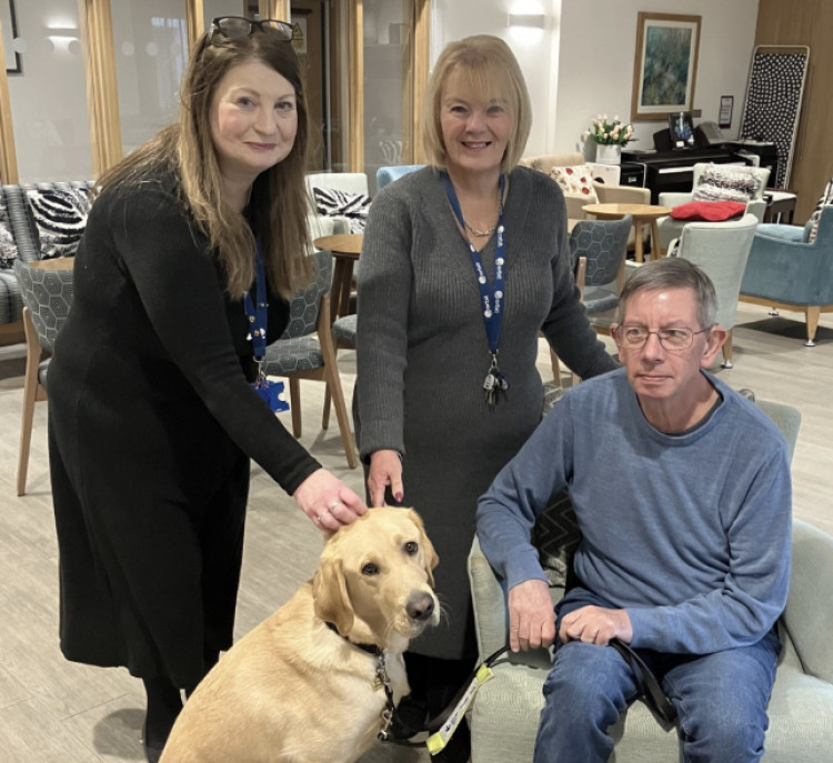 John with his guide dog Barrett alongside Orbit colleagues at Queensway Court, where residents raised £360 for Guide Dogs UK through a coffee and cake morning (Image supplied)